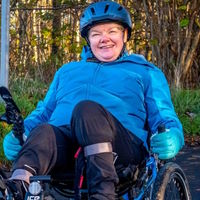 Jane pictured on her recumbent where a barrier had previously stopped her accessing the National Cycle Network.