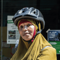 Portrait of woman in bike helmet smiling.