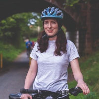 Therapeutic Radiographer Laura McGuire posing for a photo on a green cycle route in Inverness
