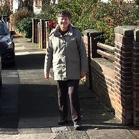 A smiling woman stood on a residential street in Liverpool 
