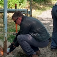 Man removing a barrier from a cycle path