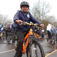 Pupil at Catherine Junior School in Leicester poses with his bike in the playground following the morning bike bus