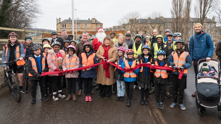 Transport and Environment Convener, Councillor Stephen Jenkinson was joined by Cabinet Secretary for Transport Fiona Hyslop, Scotland Director for Sustrans, Karen McGregor alongside groups of local schoolchildren and representatives of the Dalry community, to cut the red ribbon marking the opening of the Roseburn to Union Canal active travel route.