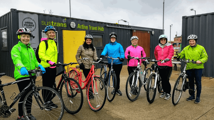 group of women with their bikes in front of Sustrans Active Travel Hub at CS Lewis Square, Belfast as part of women into cycling programme
